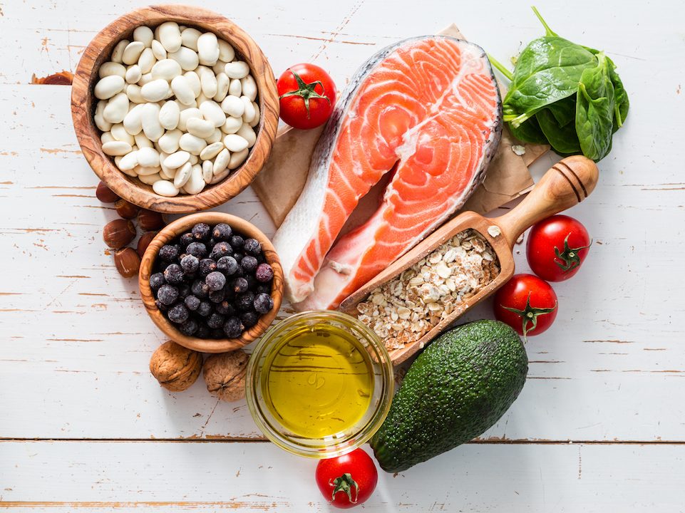 Selection of food that is good for the heart, white wood background