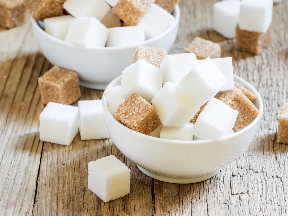 White and cane sugar in a porcelain bowls, selective focus