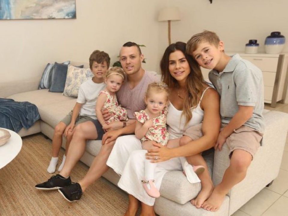Family photo of Sophie Guidolin and Nathan Wallace with kids at home|Sophie Guidolin New Year Blog Image wearing Seed|Sophie Guidolin and baby lying on the bed reading a book together