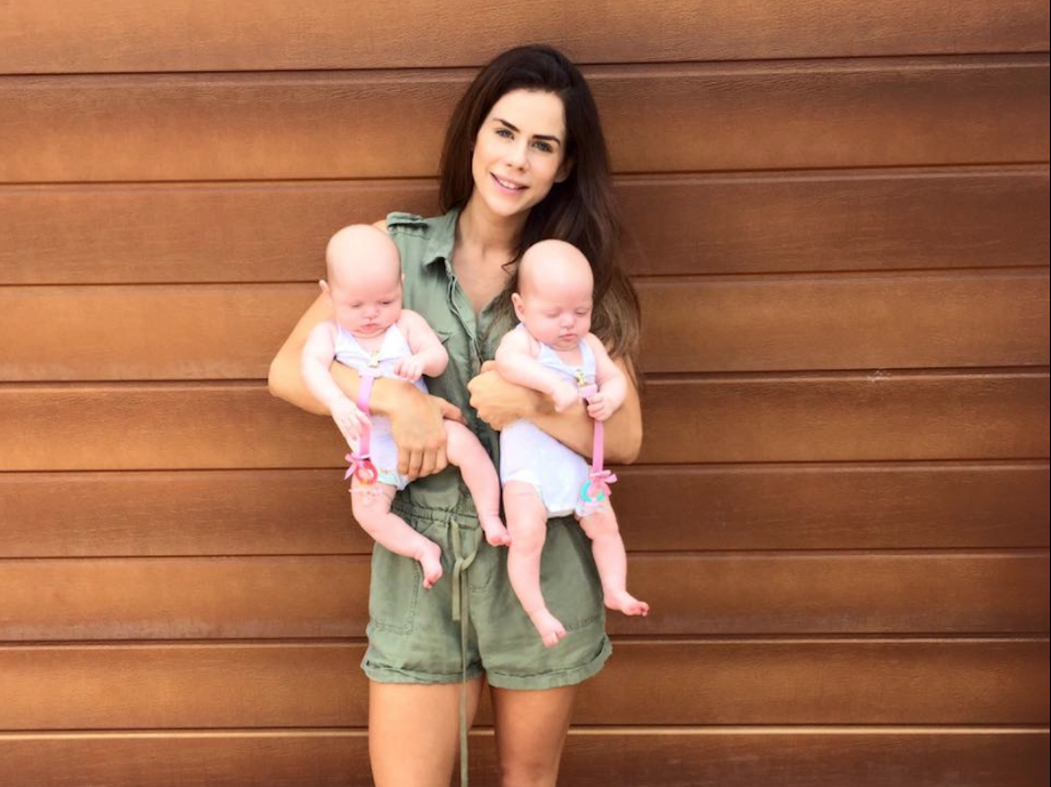 Sophie Guidolin postpartum holding her twin girls