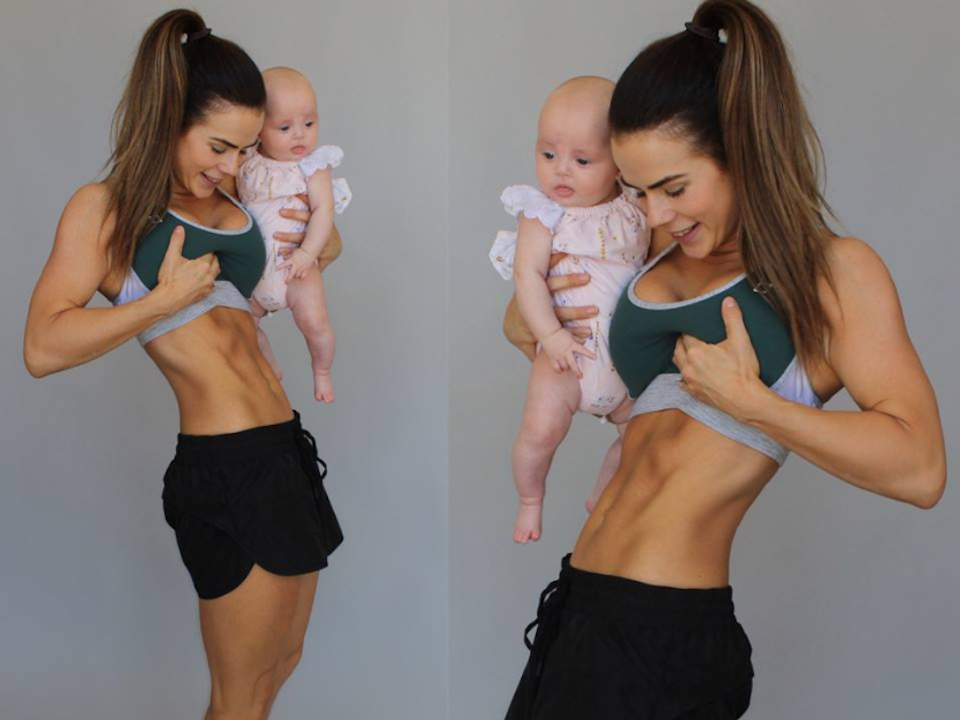 Sophie Guidolin postpartum holding baby and flexing abs in activewear