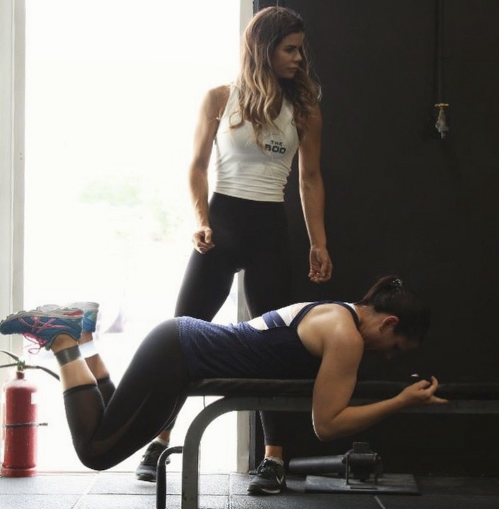 Sophie Guidolin coaching a client at the gym
